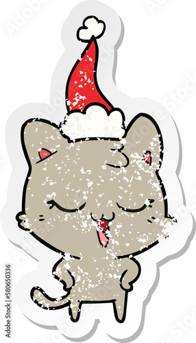 happy distressed sticker cartoon of a cat wearing santa hat