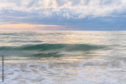 Wave crashing on a sandy beach of the Atlantic Ocean.