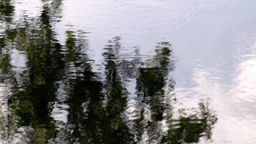 throw small rock in lake with light reflecion photo