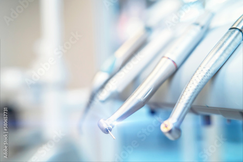 Closeup photo of dental handpieces and equipment on dental chair with blured background. photo