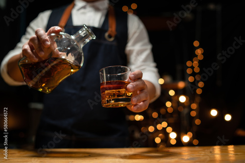 Barman pouring whiskey whiskey glass beautiful night