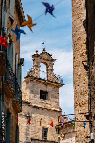 Beautiful medieval house stone facade and colorful garland in the old town of Pezenas in the south of France (Herault) photo