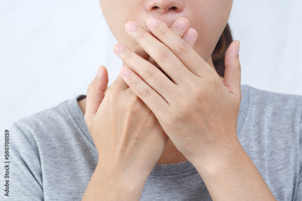 Asian woman checking her breath with hand test. Health Care concept.