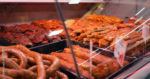 Quadro em tela Fresh raw and marinated meat with tags on the showcase in the butchers store