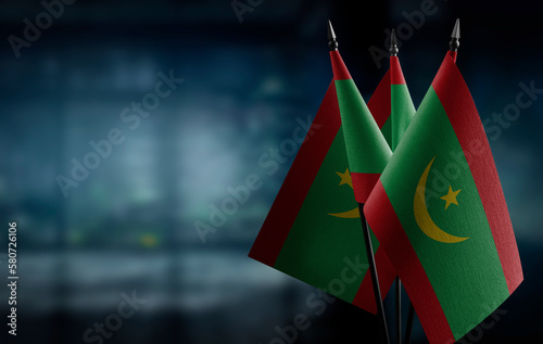 Small flags of the Mauritania on an abstract blurry background
