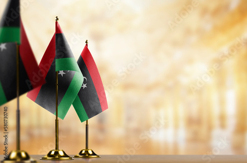 Small flags of the Libya on an abstract blurry background