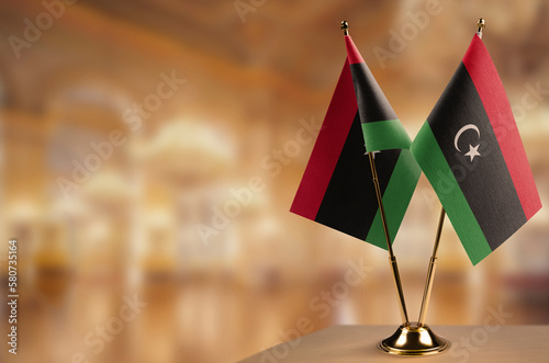 Small flags of the Libya on an abstract blurry background