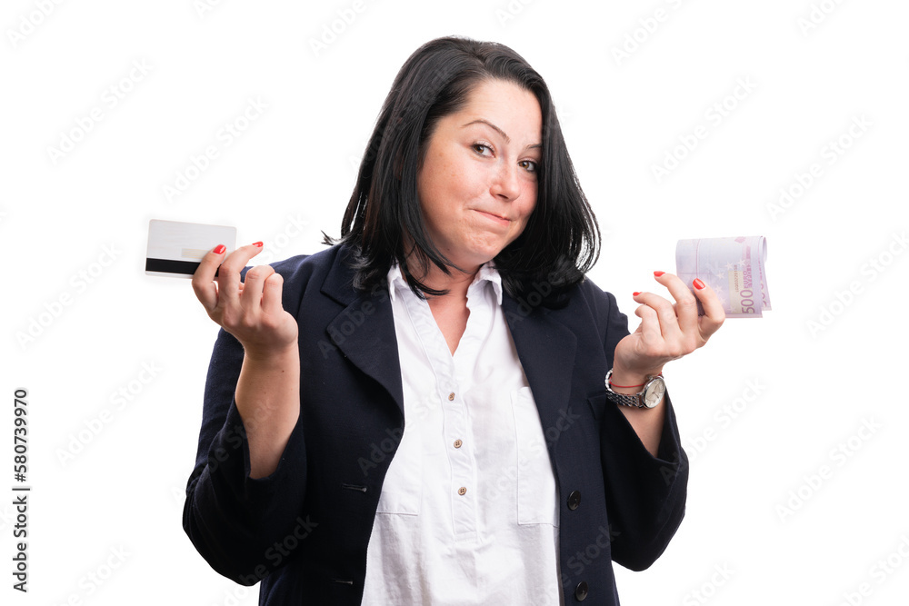 Confused businesswoman comparing cash or contactless payment Confused businesswoman comparing cash or contactless payment