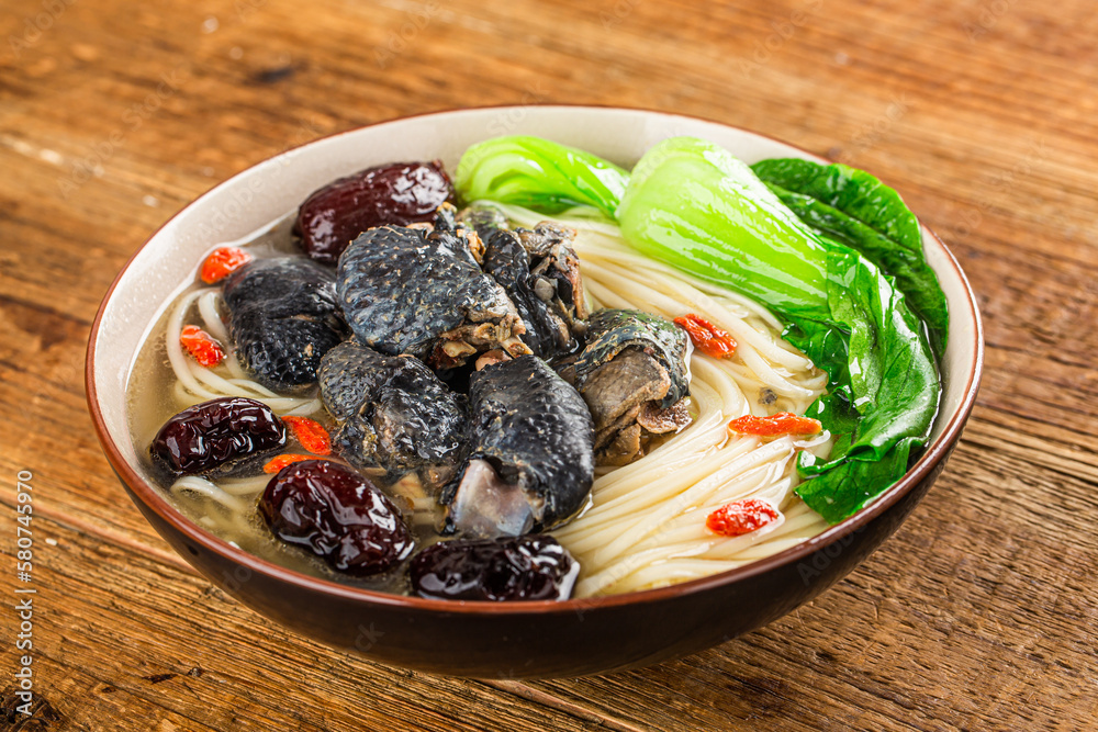 A bowl of black chicken noodles