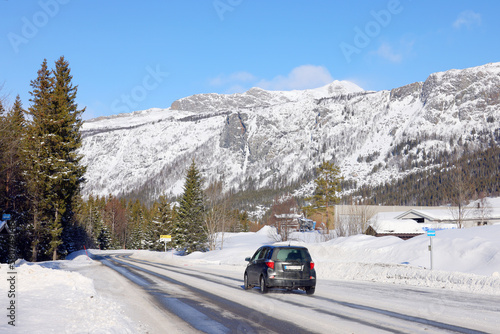 Winter landscape with snow covered mountains and an icy road in the north of Norway, Europe