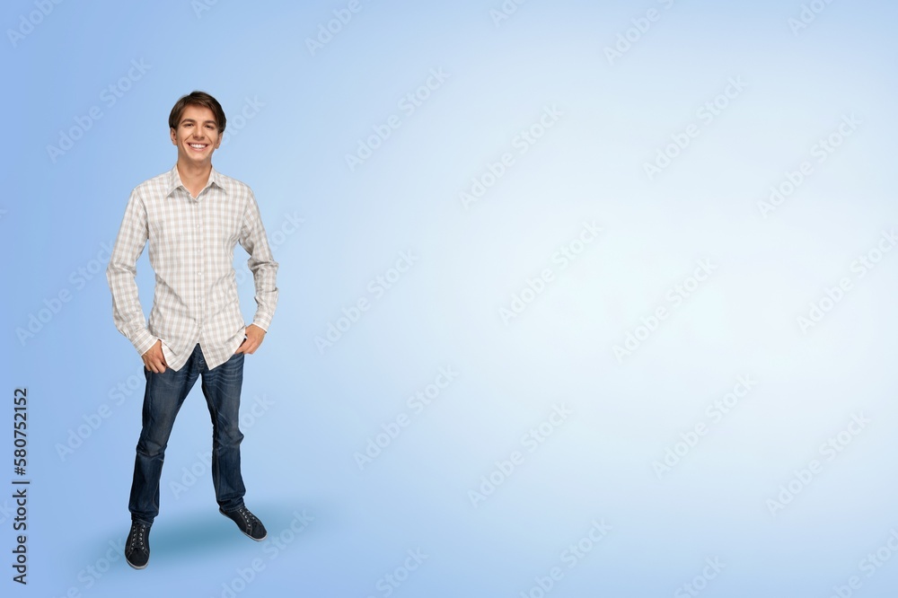 Happy young man posing on color background