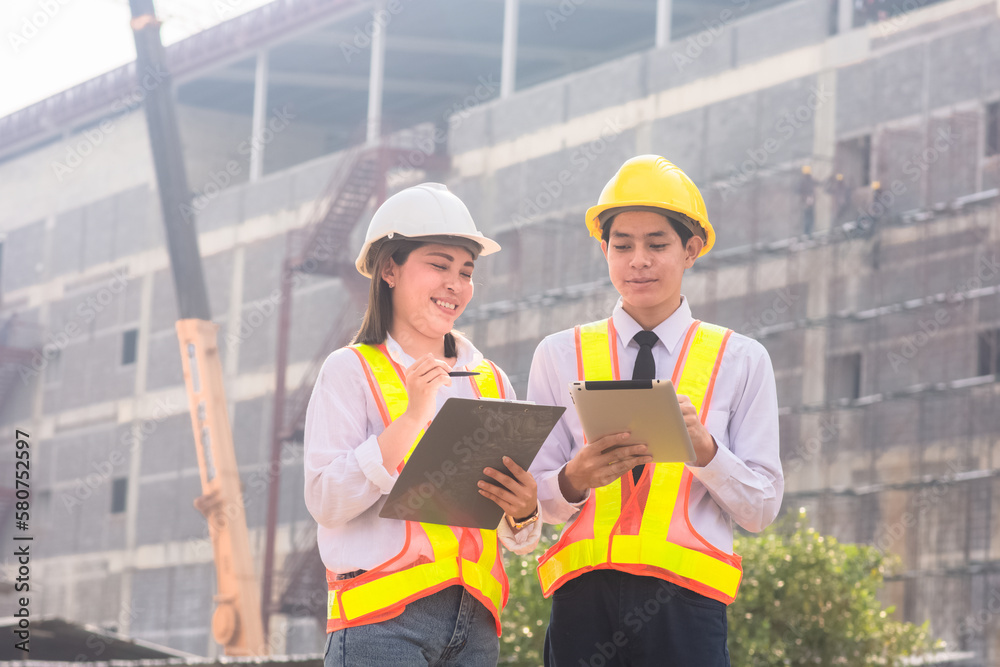 Asian team Engineer standing talking about construction project background Asian team Engineer standing talking about construction project background
