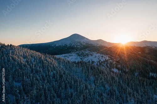 Background with amazing sunset. Winter aerial landscape of majestic Carpathian mountains