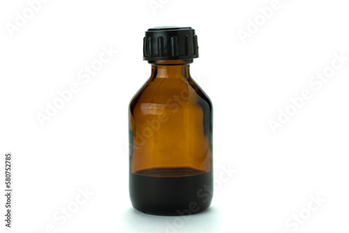 Brown glass medical bottle with liquid and black plastic cap, isolated on white.