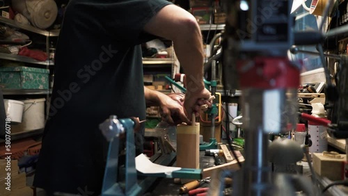 Wood designer. Man in his workshop working on wood. Carpenter using tools to work on wood.
