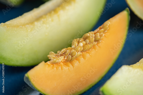 Honeydew melon and Japanese melon slice fresh ripe orange and sweet green slice lay on leaf in plant. Melon or cantaloupe is sweet fruit dessert. photo