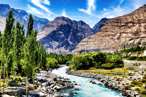 Gushing turquoise water of Gizer River, passing through a contrasting mountains in Gilgit-Baltistan, Pakistan  