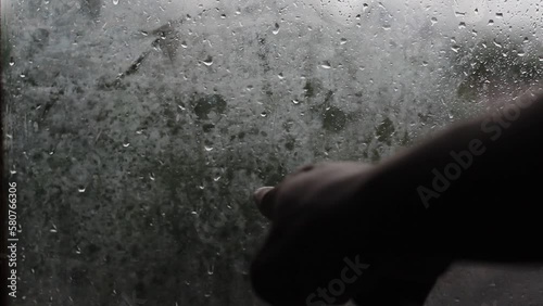 Close-up of water drops on glass, Raining Rain, Gone. Huge raindrops hit the window pane during summer shower. Rainstrom  photo