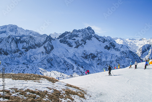 A beautiful scenery of the italian Alps with skiing people. Ponte di Legno, Italy.