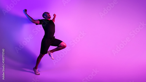 Black Athlete Man Running Celebrating Victory Shouting Over Purple Background