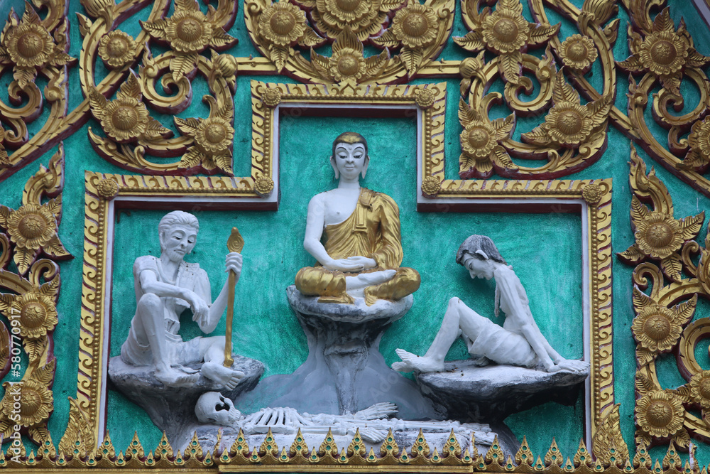 Relief carvings in a Hua Hin temple. The Buddha encounters life's hardships. Thailand.