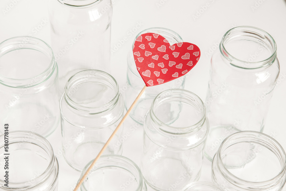 Assorted set of glass containers without lids on white background, recycling. Concept of second life to materials, various uses for glass vials. Assorted set of glass containers without lids on white background, recycling. Concept of second life to materials, various uses for glass vials.
