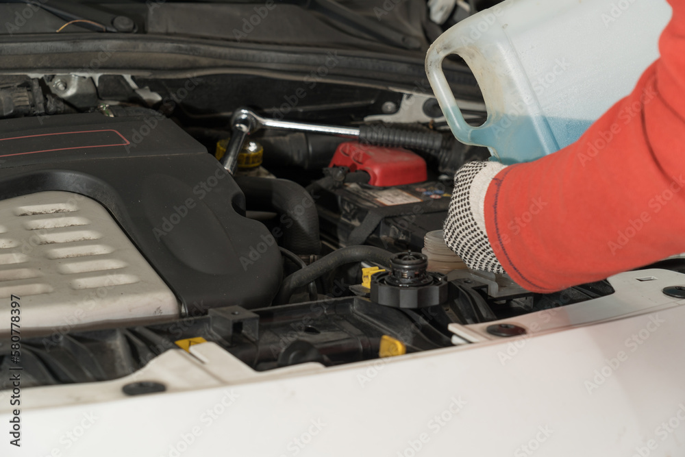 Auto mechanic working on vehicle engines in mechanical garage. Repair service. authentic close-up shot Auto mechanic working on vehicle engines in mechanical garage. Repair service. authentic close-up shot