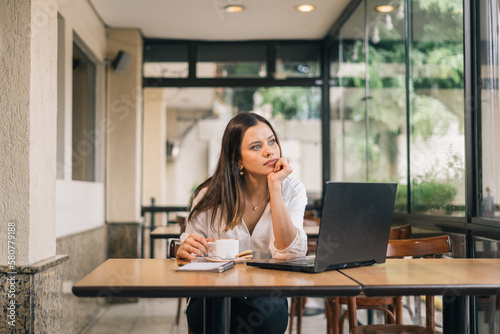 Self-employed woman, working in home room, using laptop, thinking about future vision of online project, work success, achievement, high result