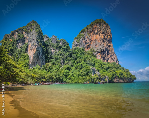 Railay west beach in Krabi district Thailand. Paradise beach with golden sand and green mountains around © Audrius