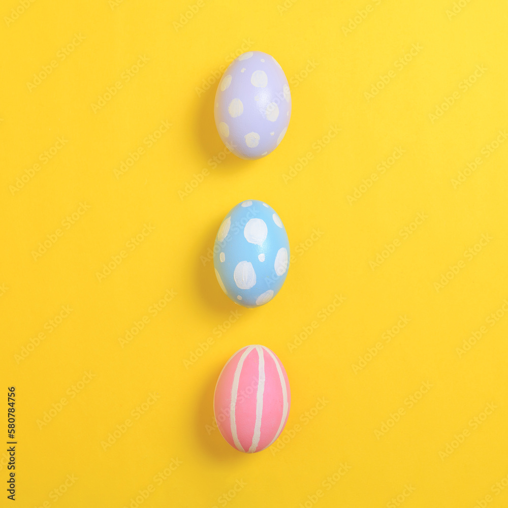 Happy easter holiday celebration concept. Group of painted colourful eggs decoration on a yellow background. Seasonal religion tradition design. Top view, flat lay, copy space. Happy easter holiday celebration concept. Group of painted colourful eggs decoration on a yellow background. Seasonal religion tradition design. Top view, flat lay, copy space.