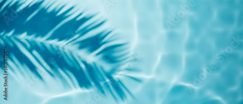 Aqua waves and coconut palm shadow on blue background. Water pool texture top view.Tropical summer mockup design. Luxury travel holiday. © hitdelight