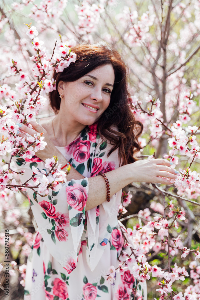 woman near pink flowering trees in peach garden nature spring woman near pink flowering trees in peach garden nature spring