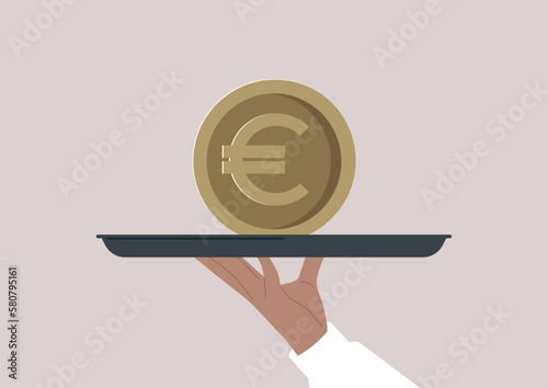 A hand holding a big euro coin on a tray