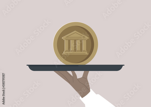 A hand holding a big coin on a tray