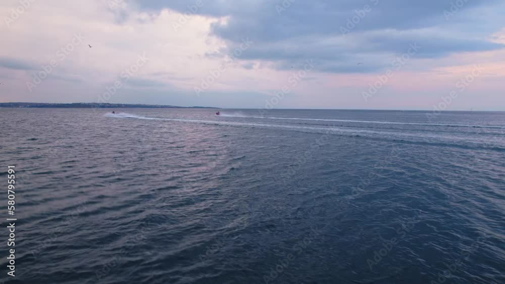 Dark Sky Jetski Coast Luxury Racing Catching Up Parallel Follow Shot to Reveal Vibrant Colorful Sunset Dark Sky Jetski Coast Luxury Racing Catching Up Parallel Follow Shot to Reveal Vibrant Colorful Sunset