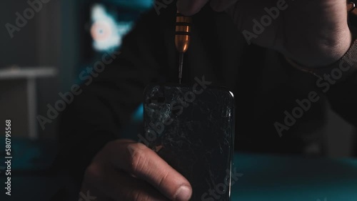 Man engineers fixing smartphone broken screen lots of close-ups b-roll. Fixing process in repair shop - repairman working with broken mobile phone, special tools on workplace.