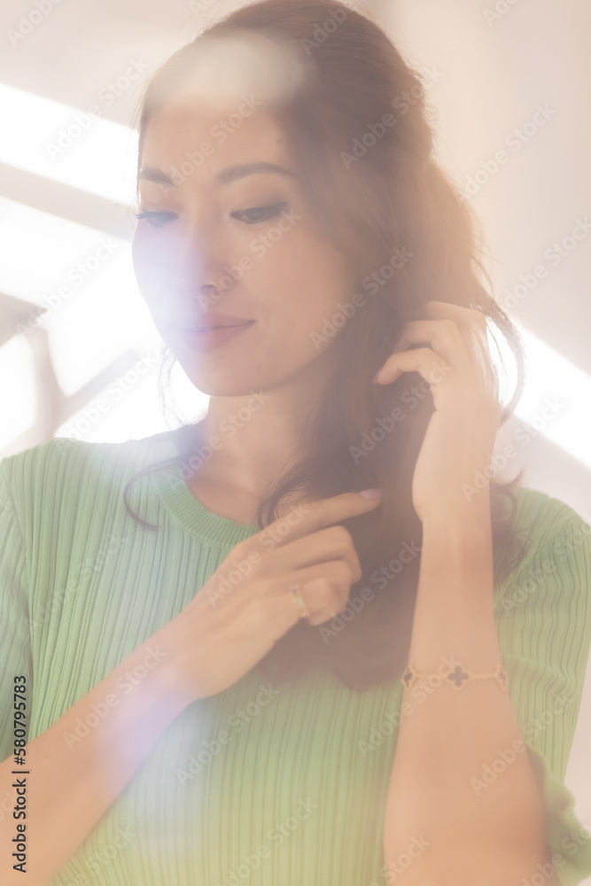 An elegant and beautiful Asian model in a green dress strikes a pose that's both graceful and captivating. Her dark hair, beautiful lips, and attractive facial features make for an alluring image An elegant and beautiful Asian model in a green dress strikes a pose that's both graceful and captivating. Her dark hair, beautiful lips, and attractive facial features make for an alluring image