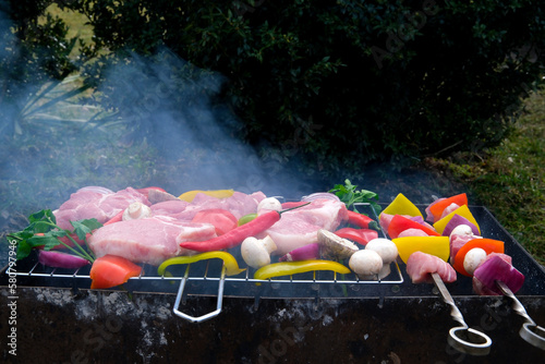 most important meat dish of Turkish cuisine kebabs is a rich product that is cooked on embers Shish kebab with mushrooms, cherry tomato and sweet pepper, Grilled meat skewers. Top view, copyspace photo