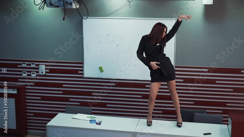 Young female sexy teacher professor dancing and having fun