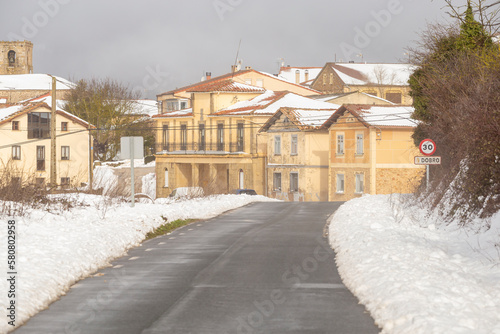 Lonely winter road that reaches to a small village