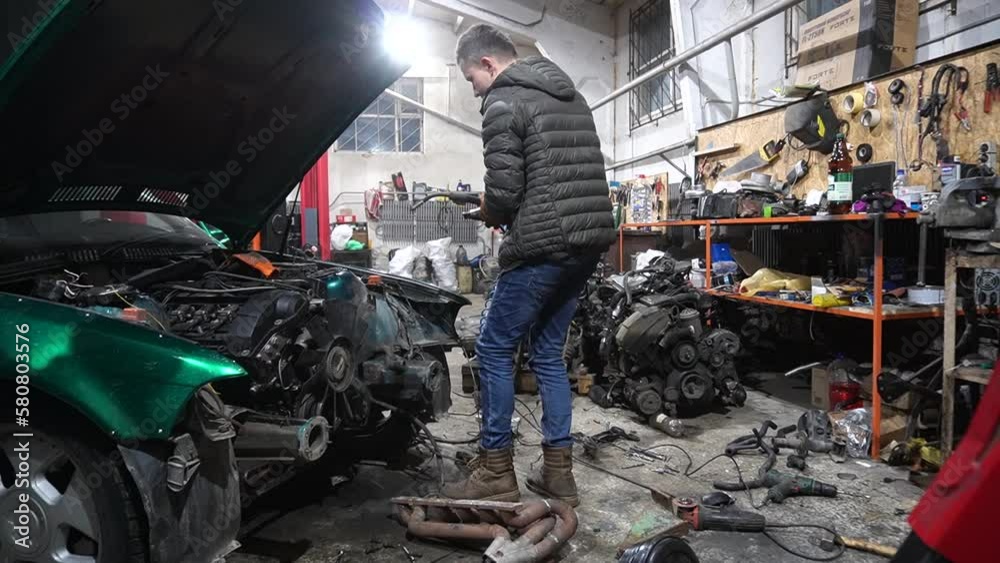 the mechanic performs cleaning work on the custom exhaust manifold and intake system for the turbo engine the mechanic performs cleaning work on the custom exhaust manifold and intake system for the turbo engine