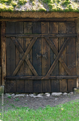 Massive makeshift wooden gates, a fragment of an old estate.