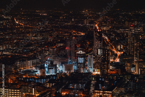 Aerial view of south west London, just after sunset, orange yellow street lights starting to glow