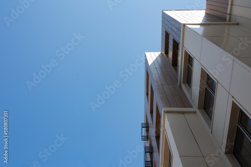 bottom view of a multi-storey building and the sky background. copy space