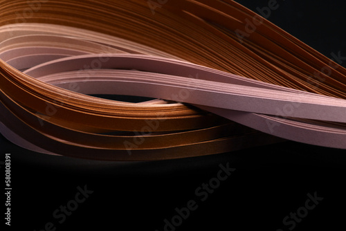 Bronze brown color strip wave paper. Abstract texture black background.