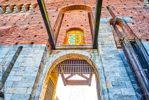 Sforza's Castle with lifting mechanism of the drawbridge and Coat of Arms above Porta del Carmini gate, Milan, Italy photo