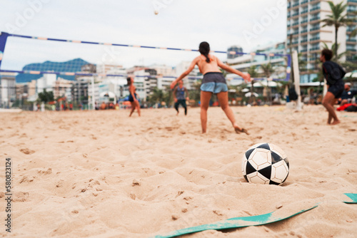 mixed group of young brazilians playing footvolley or futevolei on the beach of Ipanema, Brazil photo