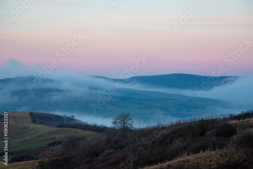 Morning fog between the hills in late autumn