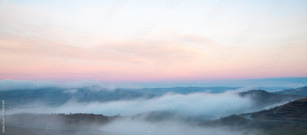 Fog in the valleys between the hills in the morning
