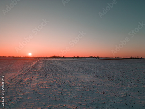 Dramatic Colorful Sunset On The Open Field In Winter. Clear Sky No Clouds